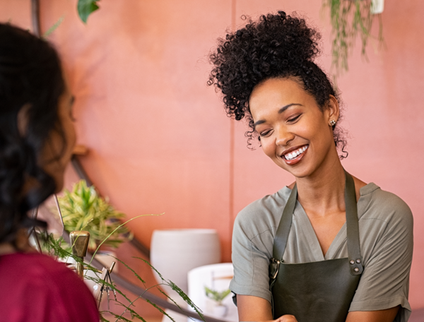 Happy woman in a shop with a payment terminal