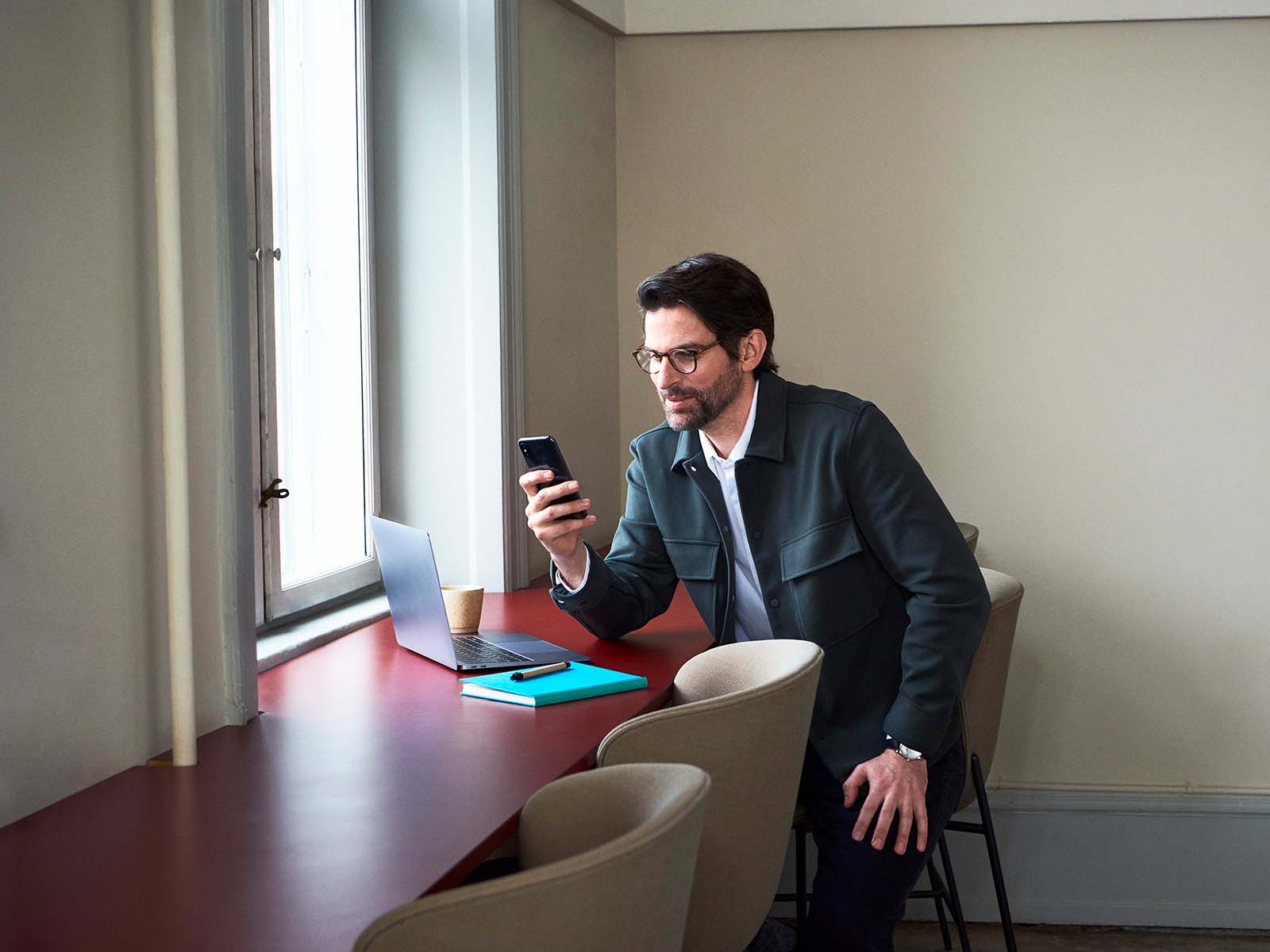 Image of a man looking at his phone.