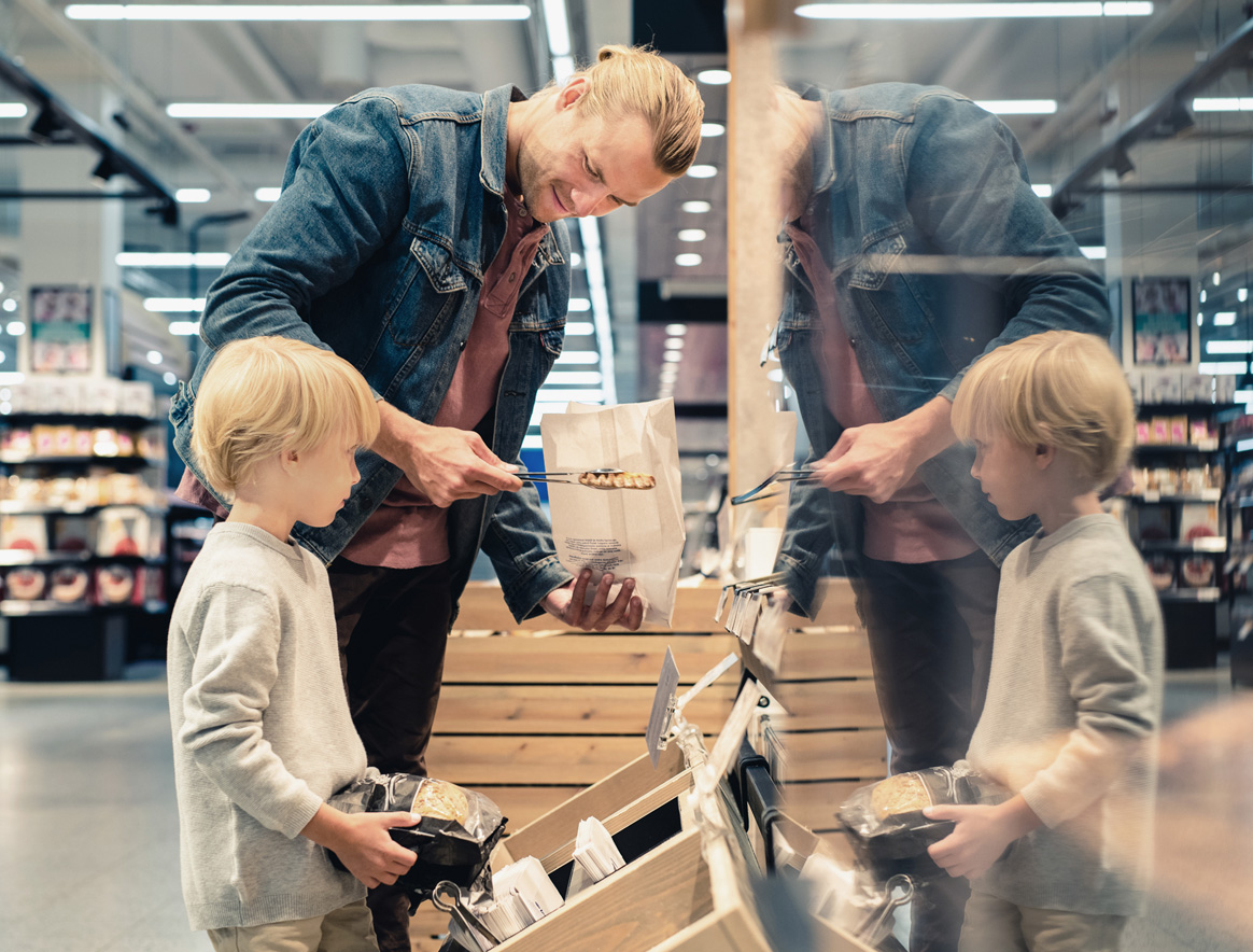 Man and a child shopping in grocery store.